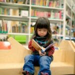 Child reading in a library